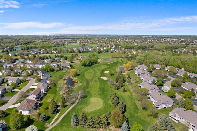 aerial overview of property's location with nearby suburban area, a golf club, and a tree filled landscape