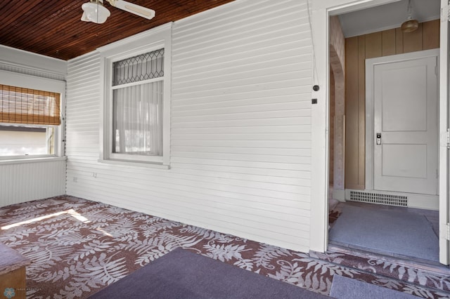 view of exterior entry featuring a ceiling fan