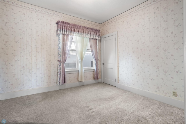 carpeted spare room with wallpapered walls