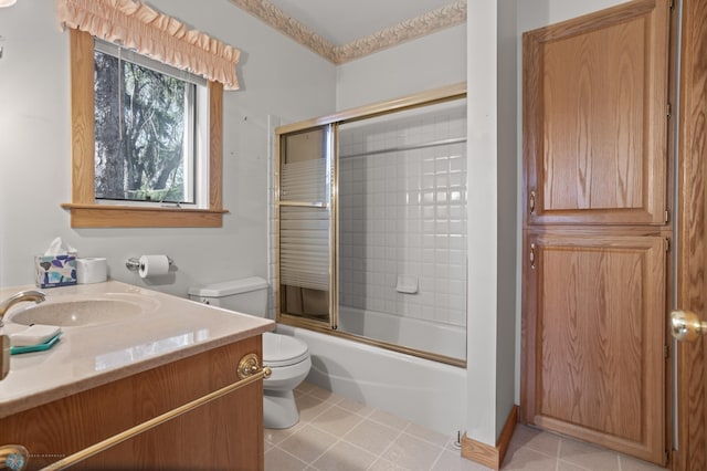 full bath with toilet, enclosed tub / shower combo, vanity, and tile patterned floors