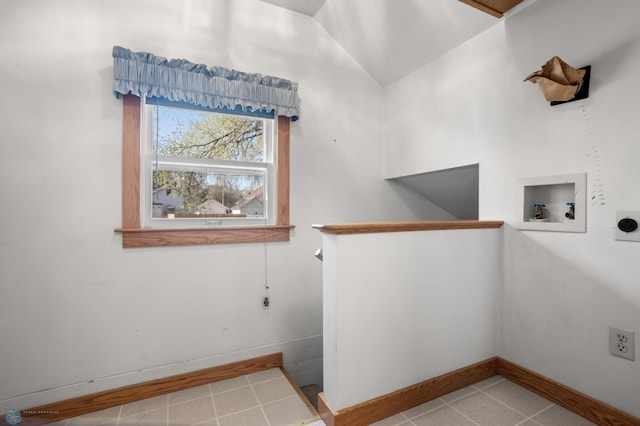 washroom with electric dryer hookup, tile patterned flooring, washer hookup, and baseboards