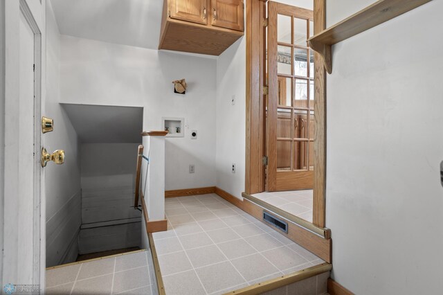 mudroom featuring baseboards and light tile patterned floors