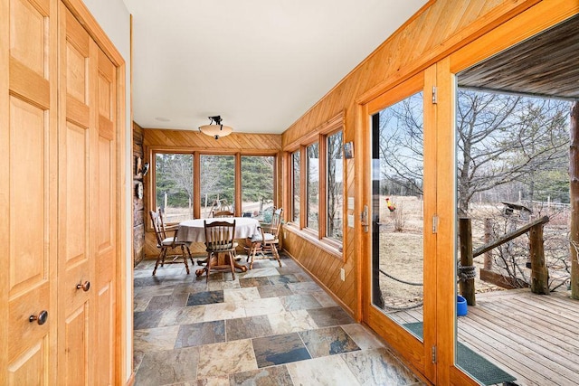 3213 Alger Grade, Silver Creek Twp, MN 55616 - sunroom featuring wooden walls and stone finish flooring