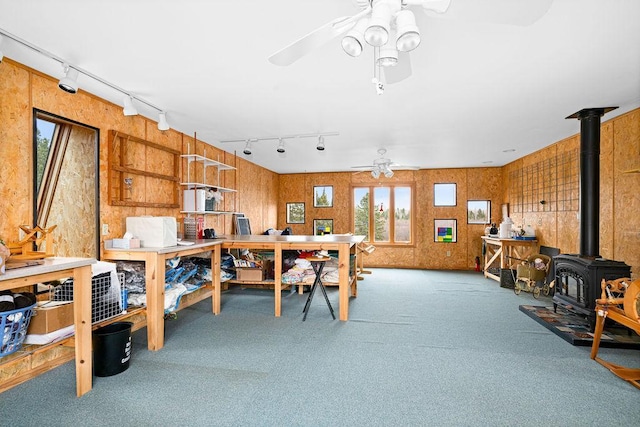 3213 Alger Grade, Silver Creek Twp, MN 55616 - home office featuring rail lighting, a ceiling fan, carpet floors, and a wood stove