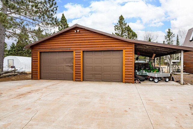 3213 Alger Grade, Silver Creek Twp, MN 55616 - garage with driveway and a detached garage