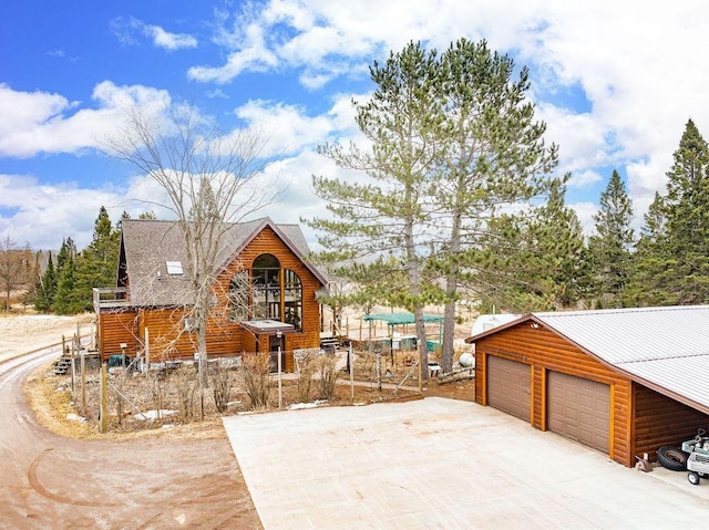 3213 Alger Grade, Silver Creek Twp, MN 55616 - view of front facade with a detached garage and faux log siding