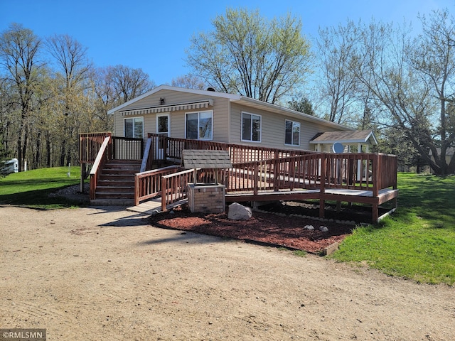 view of front of home with a wooden deck and a front yard