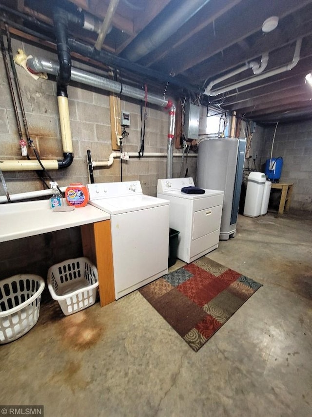 below grade area featuring washer and dryer, water heater, and a water softener