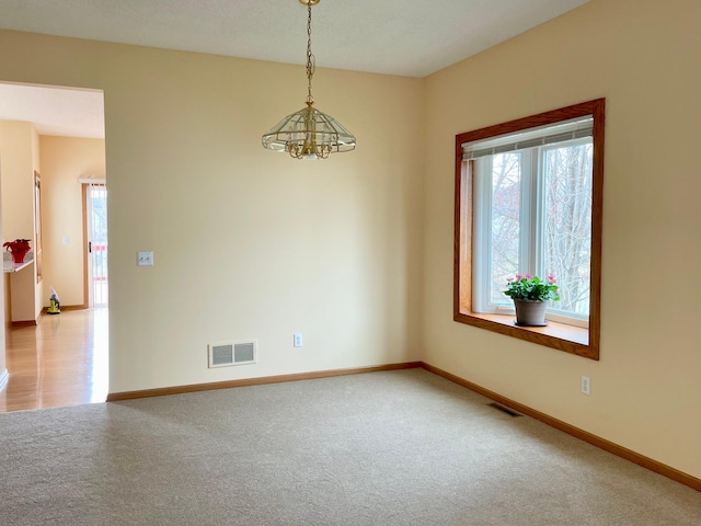 1986 Mathias Rd, Shakopee, MN 55379 - spare room with a chandelier, carpet floors, and baseboards