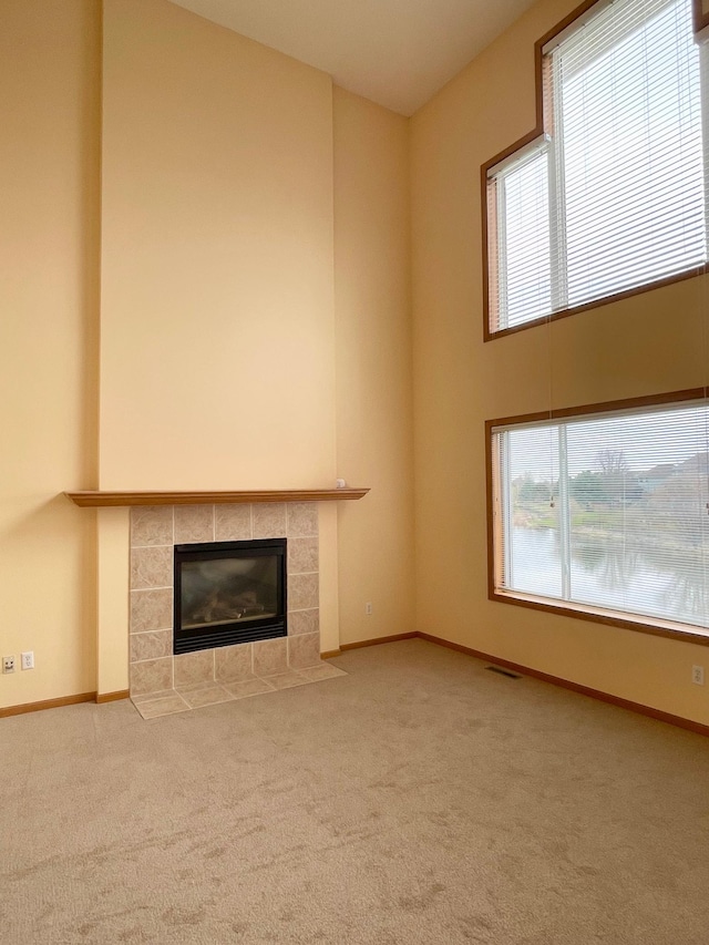 1986 Mathias Rd, Shakopee, MN 55379 - unfurnished living room featuring a tile fireplace, carpet, and baseboards
