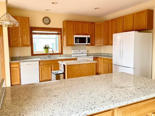 1986 Mathias Rd, Shakopee, MN 55379 - kitchen with white appliances, a sink, light stone counters, a kitchen island, and recessed lighting