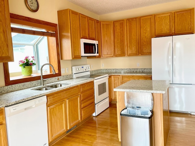 1986 Mathias Rd, Shakopee, MN 55379 - kitchen with white appliances, a sink, light wood finished floors, and light stone counters