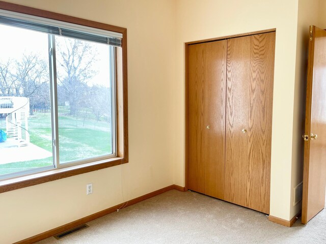 1986 Mathias Rd, Shakopee, MN 55379 - unfurnished bedroom featuring a closet, light colored carpet, and baseboards