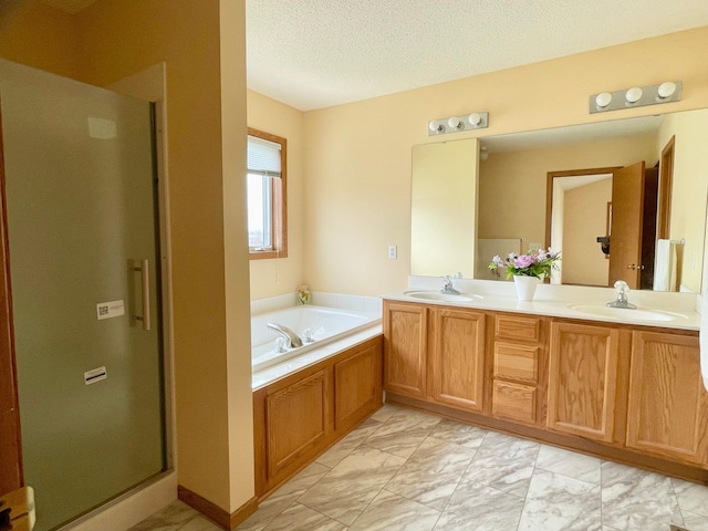 1986 Mathias Rd, Shakopee, MN 55379 - bathroom featuring marble look tile flooring, double vanity, a garden tub, a stall shower, and a textured ceiling
