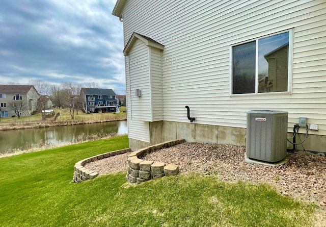 1986 Mathias Rd, Shakopee, MN 55379 - view of home's exterior featuring central AC unit, a yard, and a water view