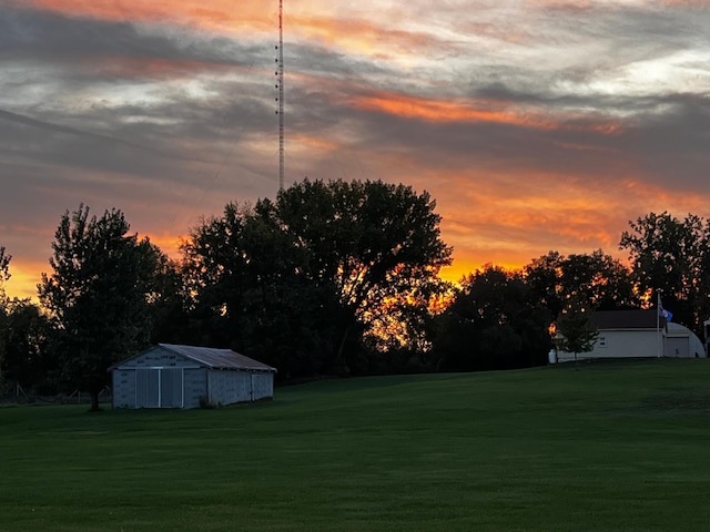 12235 323rd St, Princeton, MN 55371 - yard at dusk featuring a yard, an outbuilding, and a pole building