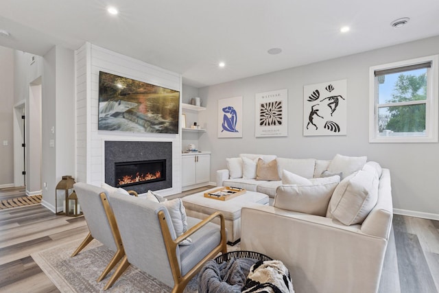 6813 5th St N, Brooklyn Center, MN 55430 - living room with a glass covered fireplace, baseboards, wood finished floors, and recessed lighting