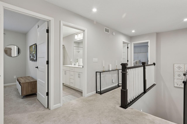 6813 5th St N, Brooklyn Center, MN 55430 - corridor featuring an upstairs landing, light colored carpet, recessed lighting, baseboards, and a sink