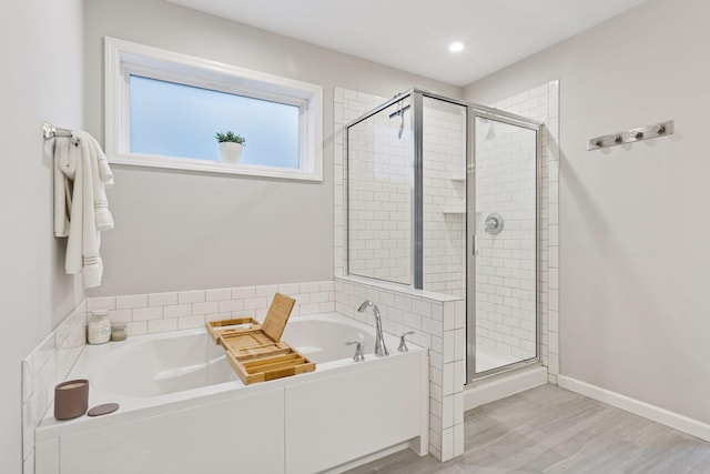 6813 5th St N, Brooklyn Center, MN 55430 - full bathroom featuring a garden tub, a shower stall, wood finished floors, and recessed lighting