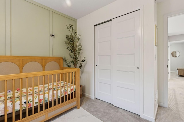 6813 5th St N, Brooklyn Center, MN 55430 - carpeted bedroom with a closet, a crib, and baseboards