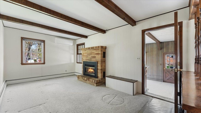 unfurnished living room with a wall unit AC, beamed ceiling, carpet floors, a brick fireplace, and a baseboard heating unit