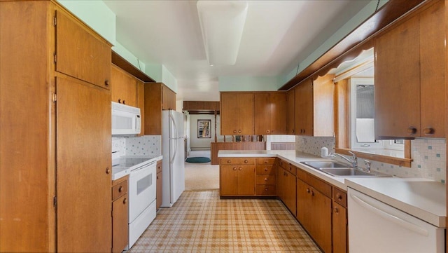kitchen featuring white appliances, a sink, light countertops, light floors, and tasteful backsplash