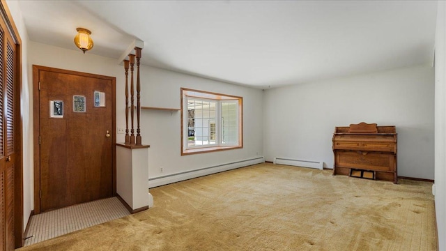 carpeted entrance foyer with baseboard heating