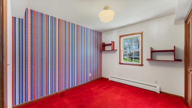 spare room with a baseboard radiator and carpet floors
