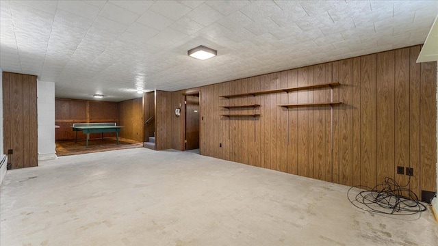 finished below grade area with wooden walls and billiards table