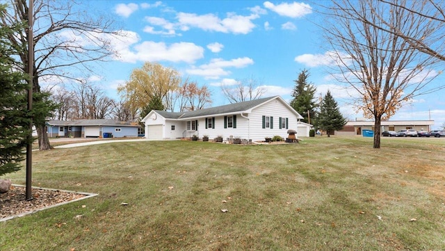 view of front of house featuring an attached garage and a front lawn