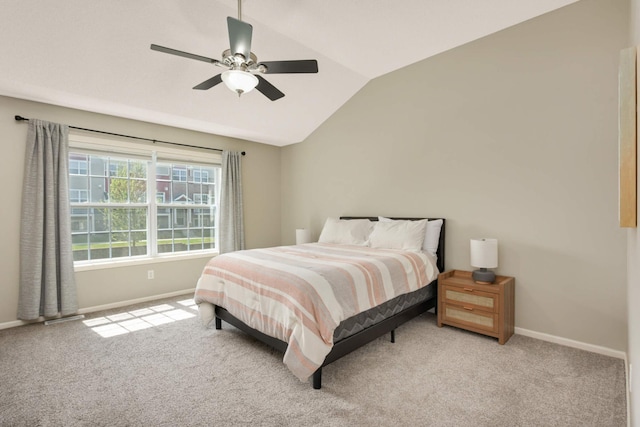 bedroom with vaulted ceiling, baseboards, carpet floors, and ceiling fan