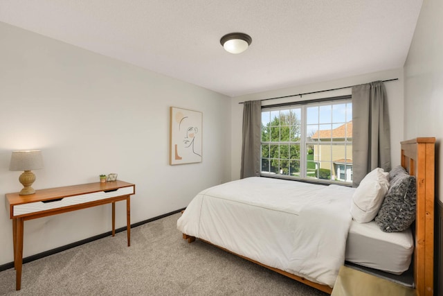 carpeted bedroom featuring baseboards