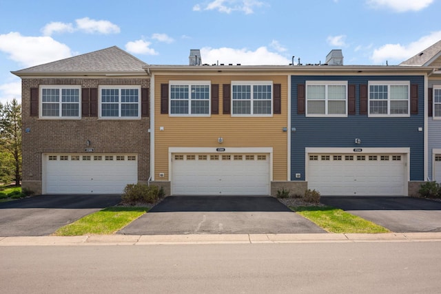 17208 72nd Ave N, Maple Grove, MN 55311 - multi unit property with driveway, an attached garage, a chimney, and brick siding