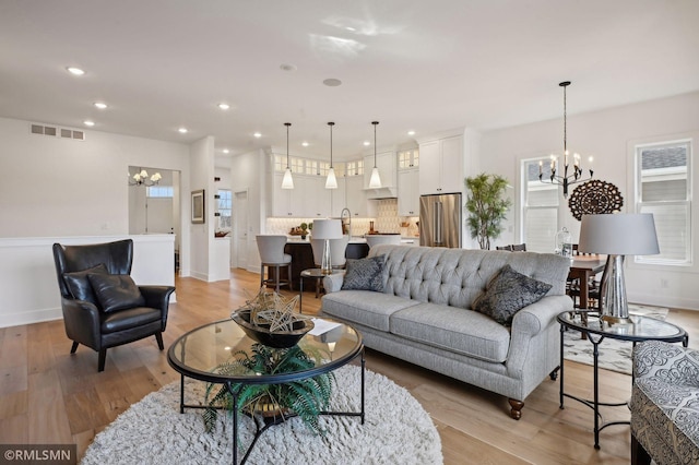 13708 Park Haven Trl, Prior Lake, MN 55372 - living room with a chandelier, light wood-style flooring, recessed lighting, and baseboards