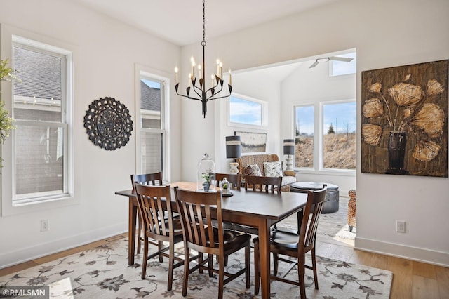 13708 Park Haven Trl, Prior Lake, MN 55372 - dining room with light wood-type flooring, a chandelier, baseboards, vaulted ceiling, and ceiling fan