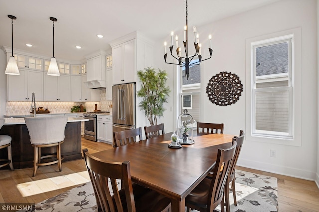 13708 Park Haven Trl, Prior Lake, MN 55372 - dining space featuring light wood-style floors, a chandelier, baseboards, and recessed lighting