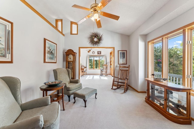 sitting room with lofted ceiling, carpet, a ceiling fan, and baseboards