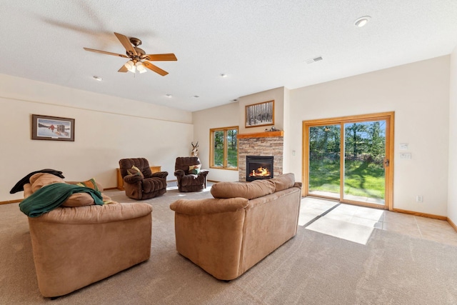 living area with a stone fireplace, carpet flooring, a ceiling fan, baseboards, and recessed lighting