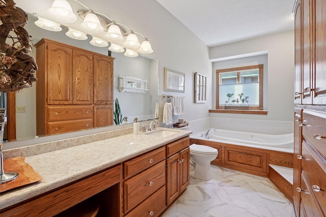 bathroom with a garden tub, marble finish floors, vanity, and toilet