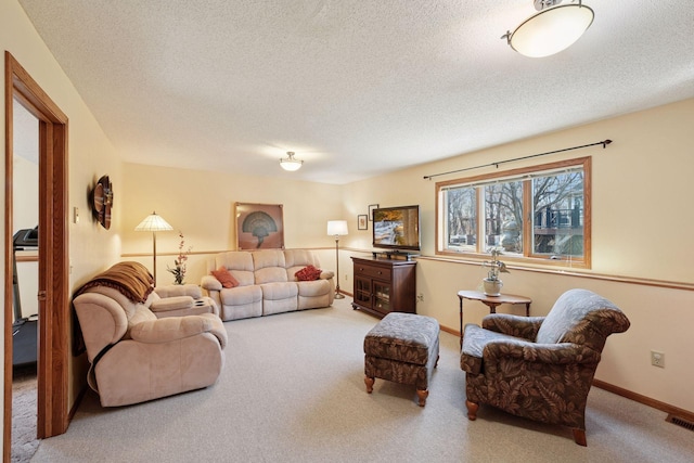 carpeted living room featuring a textured ceiling and baseboards