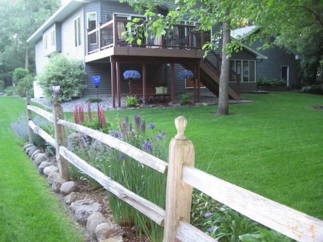 view of yard featuring a deck and stairway