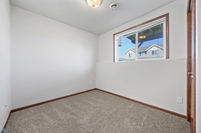 carpeted spare room with baseboards