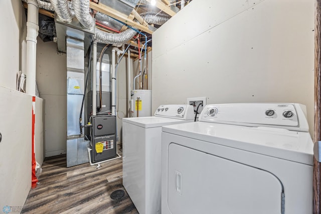washroom featuring independent washer and dryer, water heater, wood finished floors, and heating unit