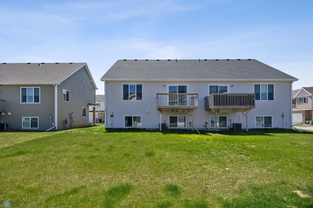 rear view of property with a yard and cooling unit