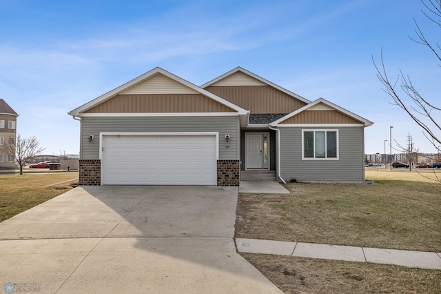 view of front of property with an attached garage, brick siding, concrete driveway, and a front lawn
