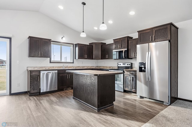 kitchen with stainless steel appliances, dark brown cabinetry, wood finished floors, decorative light fixtures, and recessed lighting