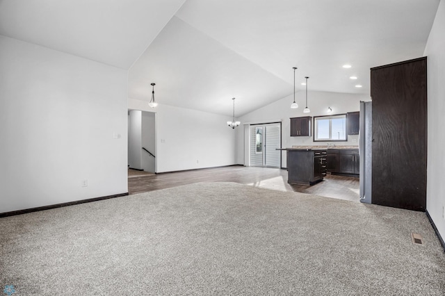 unfurnished living room with light colored carpet, lofted ceiling, a chandelier, baseboards, and recessed lighting