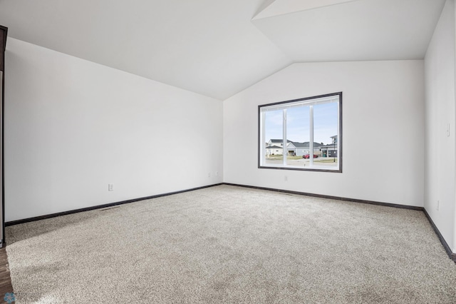 bonus room with lofted ceiling, carpet, and baseboards