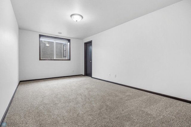 carpeted spare room with baseboards