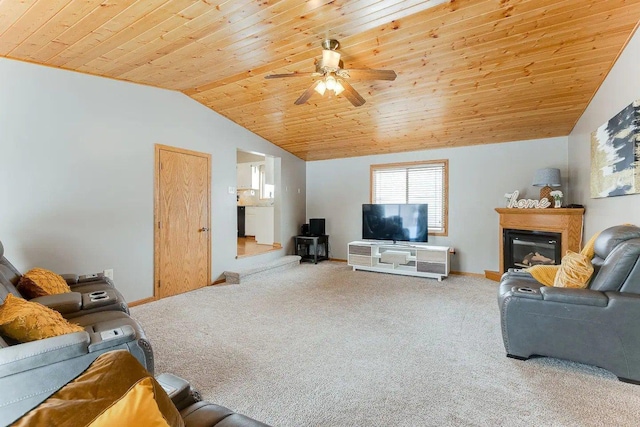 living area featuring lofted ceiling, carpet flooring, wood ceiling, ceiling fan, and a glass covered fireplace